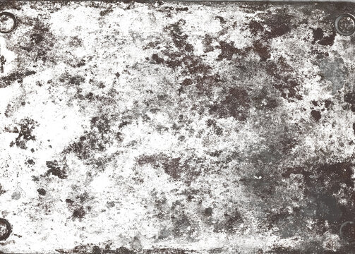Texture of an old metal plate, traces of rust, abrasions, mounting holes in the corners.