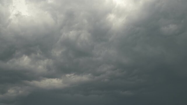 timelapse of textured storm clouds pierced by light