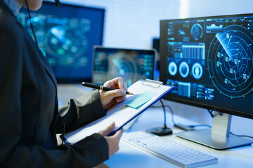 Professional monitoring aviation data on digital radar screens, analyzing flight tracking, aircraft navigation and advanced aerospace technology
