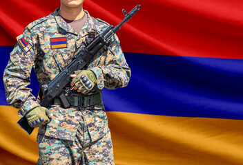 Fototapeta premium Armenia flag with soldier holding assault rifle