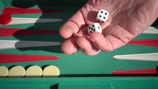Hirtshals, Denmark Two people playing backgammon while rolling dice. 