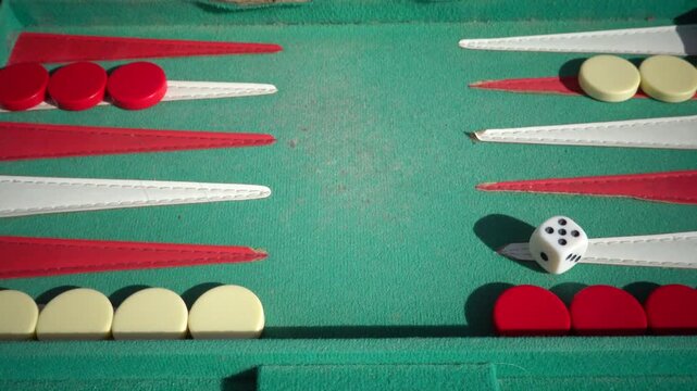 Hirtshals, Denmark Two people playing backgammon while rolling dice. 