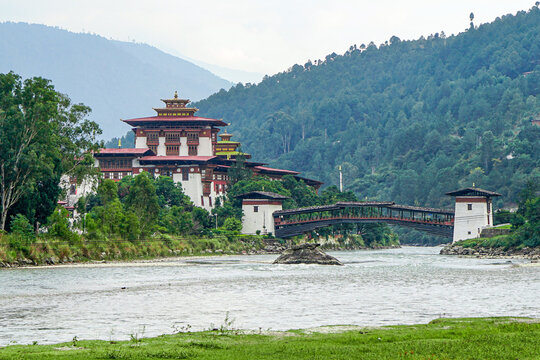Bhutan, the Dzong of Phunakha situated next the river with his pedestrian bridge 

