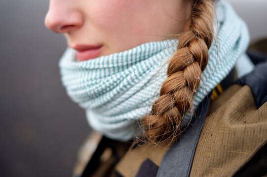 Drops from fog in pigtail of young woman