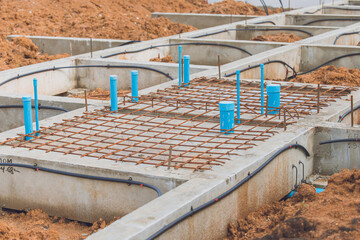 Obraz na płótnie Canvas Foundation Footing in construction site, Shallow Foundation ground floor concrete beams and water pipeline structure