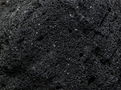 Black volcanic rock surface texture with volcanic background material abstract close-up