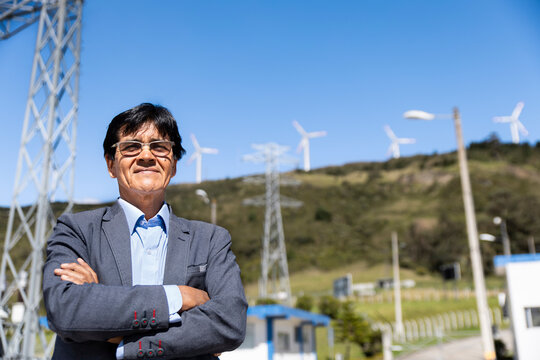Male engineer stands at a wind farm substation in Loja Ecuador