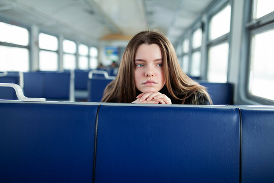 A young woman takes a winter trip on a commuter train