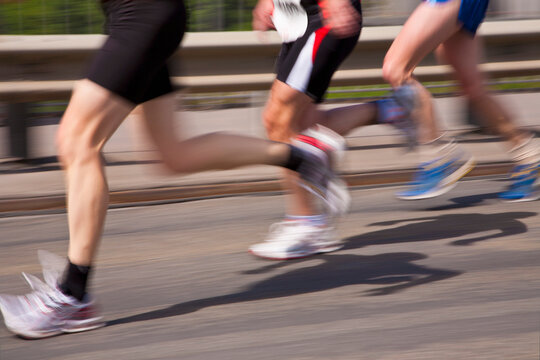 Blurred legs of runners in motion during a city sprint in Stuttgart