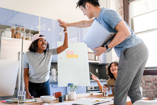 Teamwork celebration in modern office