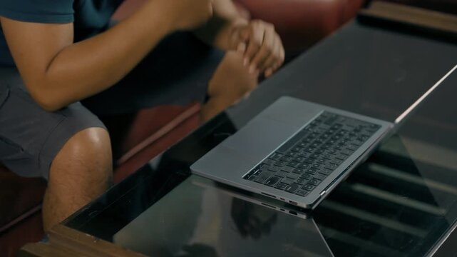 Closeup of man hands using touchpad on laptop keypad. Unrecognized freelancer browsing internet computer doing online report in agency. Student employee study remotely at desk.