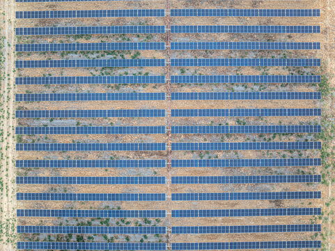 Aerial view of the Ellensburg solar farm featuring rows of photovoltaic panels arranged in a geometric pattern across the arid landscape in Ellensburg, Washington, United States.