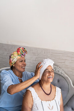 Multigenerational women bonding, smiling, laughing, wearing turbans