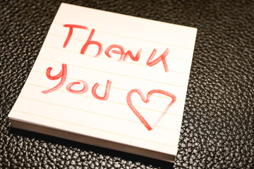 A handwritten note with the text Thank You  on it. © Sonny