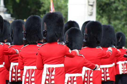 Aerial view of Queen's Guard soldiers in red tunics and bearskin hats marching in London, England, United Kingdom.