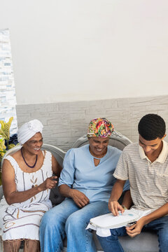 Multigenerational family sharing traditions of embroidery together