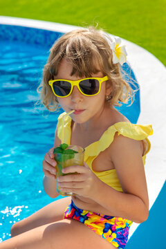 Child with juice in the pool. Selective focus.