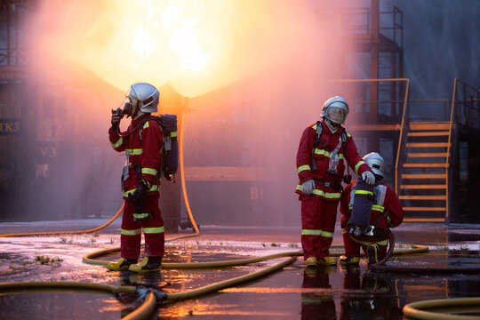 Firefighter wearing full protective equipment and breathing apparatus taking a break