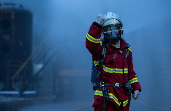 Firefighter wearing full protective equipment and breathing apparatus prepares for emergency response