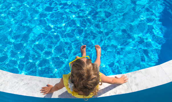 A child resting near a pool. Selective focus.