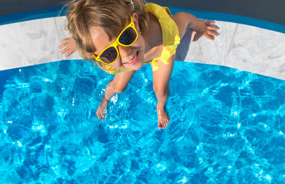 A child resting near a pool. Selective focus.