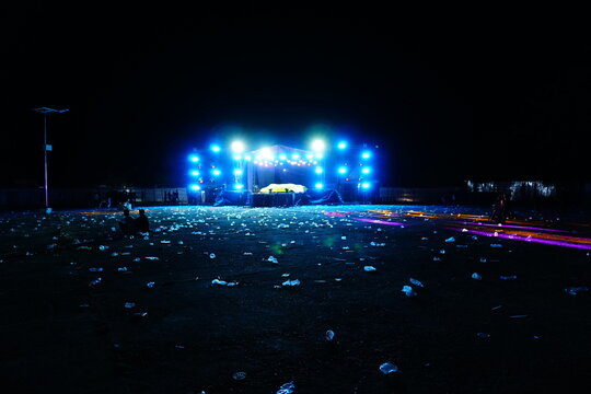 Empty Outdoor Concert Venue with Illuminated Stage at Night