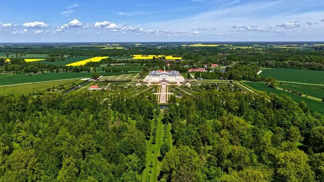 Aerial view of the historic Rundale Palace with its intricate baroque architecture and expansive formal gardens surrounded by lush green fields in Latvia.