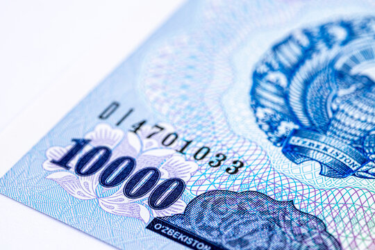 A 2017 banknote of 10000 Uzbek soums. The obverse depicts the state emblem. The reverse side of the banknote features an image of the Senate building in Tashkent.