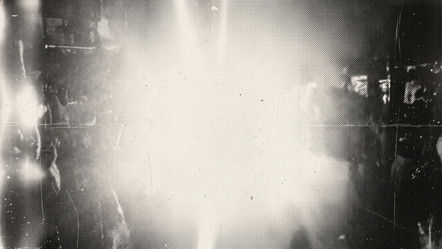 Bright overexposed central light leak vintage film texture background with scratched dark frame