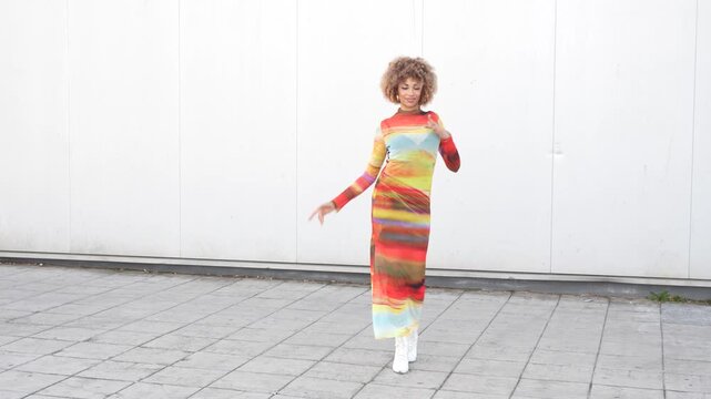 A Colorful Fashion Model Gracefully Walking Against a Stylish Minimalist Background