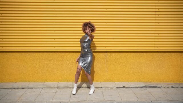 A Fashionable Model Confidently Posing Against a Bright and Vibrant Yellow Background