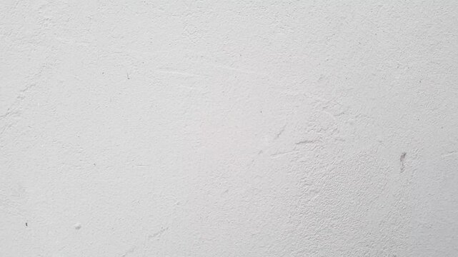 An authentic gray plastered wall of a building. A gray surface of the building with space to copy the image and insert text. A concrete wall