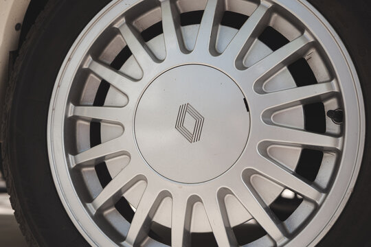 Lindau, Switzerland, August 9, 2026. Close up view of silver multi spoke alloy wheel with Renault diamond logo center cap.