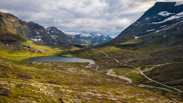 drone panorama of a small mountain lake and rugged highland terrain along the famous Trollstigen road in Norway