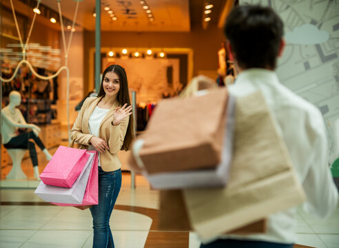Woman Waving With Bags.