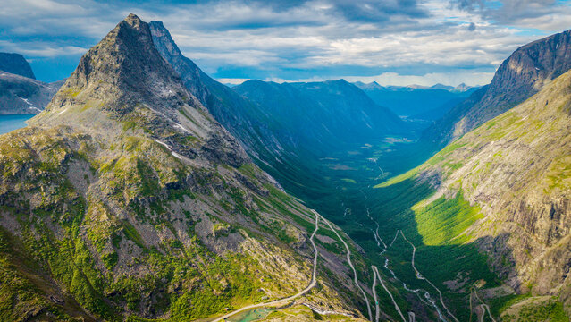 drone view capturing the dramatic canyon topography and winding road route of Trollstigen in M&oslash;re og Romsdal, Norway