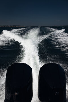 Fast Motorboat Speeding Across the Sea, Dynamic Water View from the Rear