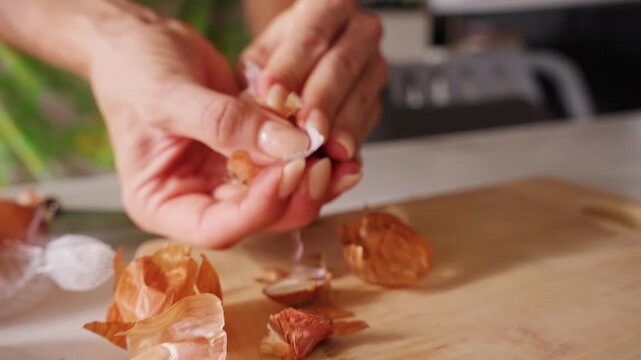 Hands Peel a Fresh Shallot on a Kitchen Counter Beside Papery Skins and Whole Bulbs, Macro Food Preparation Supporting Healthy Eating Slow motion
