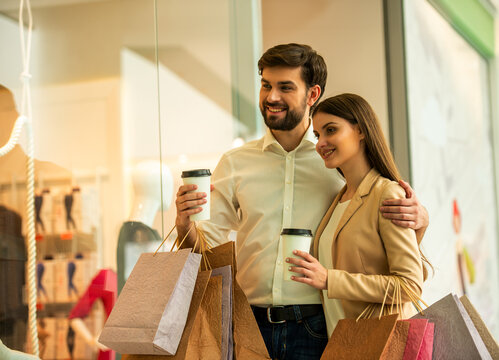 Couple Shopping With Coffee.