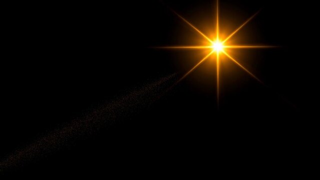 Bright golden star or sun flare with light rays and a glowing trail isolated on a black background