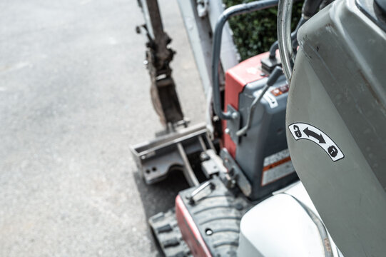 Shallow focus of the lock and unlock entry system for access to the driving seat of a mechanical digger and excavator. Seen on a roadway before excavation.