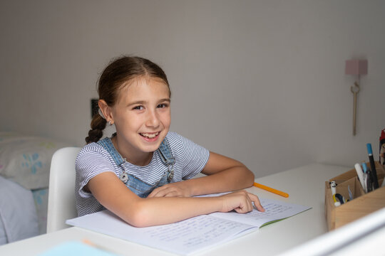 Girl Doing Homework at Her Desk
