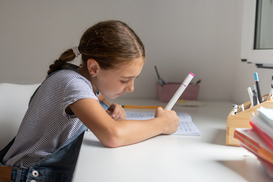 Girl Doing Homework at Her Desk