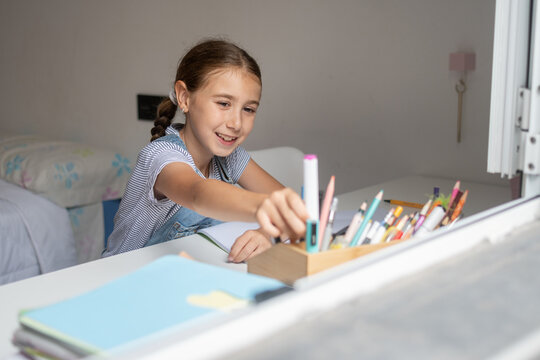 Girl Doing Homework at Her Desk