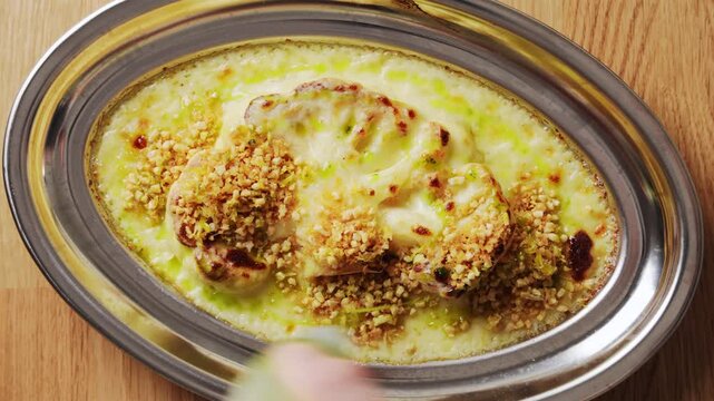 Green herb oil tops baked Mediterranean cauliflower. Add olive oil, lemon, garlic and parsley to Mediterranean cauliflower. Serve Mediterranean cauliflower with couscous, chickpeas, salad or fish.