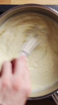 Whisk mixes grated cheese into smooth white sauce. Classic cheese sauce forms creamy base for macaroni and pasta bake. Use cheese sauce for vegetable gratin, lasagna, fish, eggs or savoury crepes.