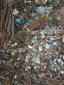 Aerial view of a large industrial scrapyard in Agnesberg featuring piles of scrap metal, rusted iron beams, and discarded industrial waste in Gothenburg, Vastra Gotaland, Sweden.