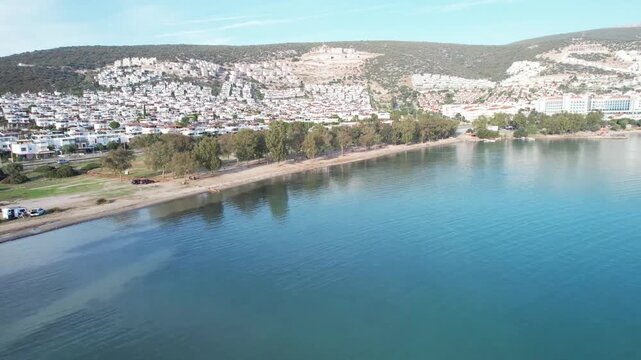 Aerial Drone View of Akbuk Coastal Town and Sandy Beach Along Aegean Shoreline in Didim Turkey