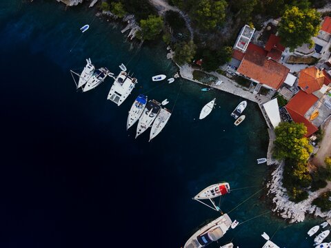 Aerial view of boats in a croatian coastal village harbor
