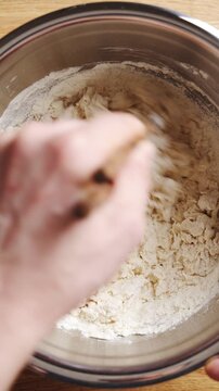 Chopsticks stir flour and water, starting smooth udon dough. Salt and wheat flour give udon dough firm, elastic texture. Cut udon dough into thick noodles for soup, stir-fry, curry or cold salad.